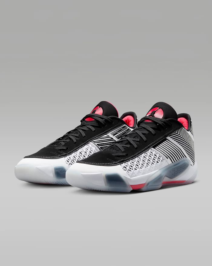 Side view of white, black, and red Air Jordan sneakers.